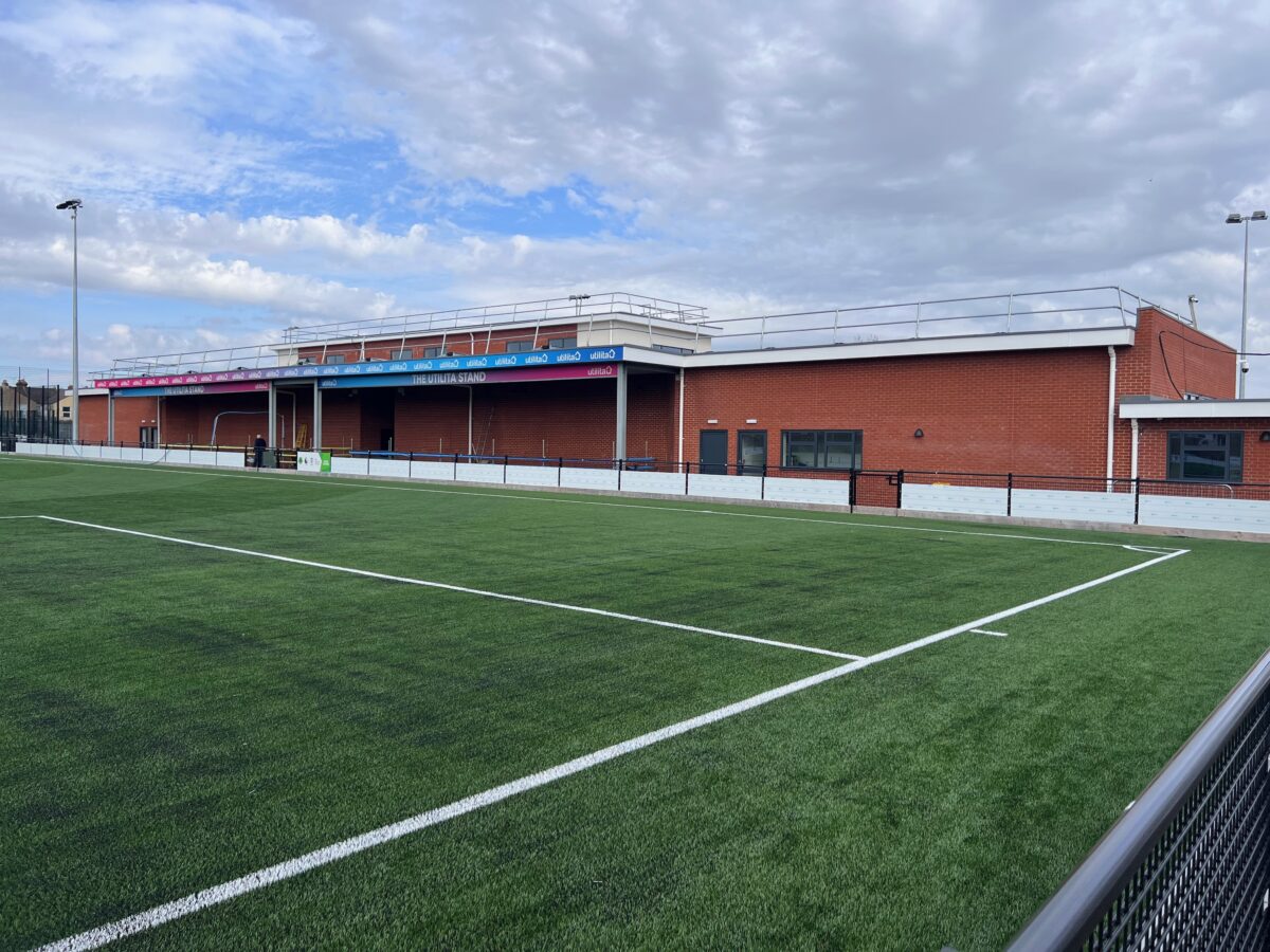 Photo from the Stadium Pitch at the John Jenkins Stadium of the stand and Utilita branding