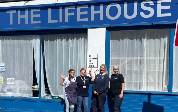 4 women standing outside The Life House Portsmouth who represent The Life House, Pompey in the Community, MAKE and Spark Community Space celebrating a donation from the Eisner Foundation